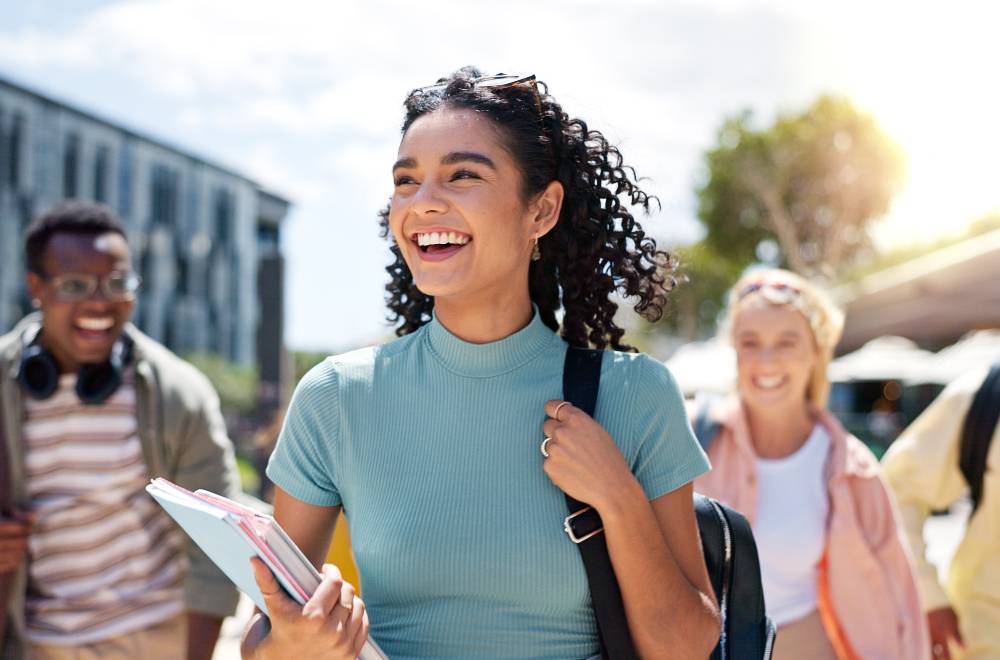 Students standing on a university campus, showcasing the vibrant campus life that a higher education digital marketing agency can help promote through effective online strategies.