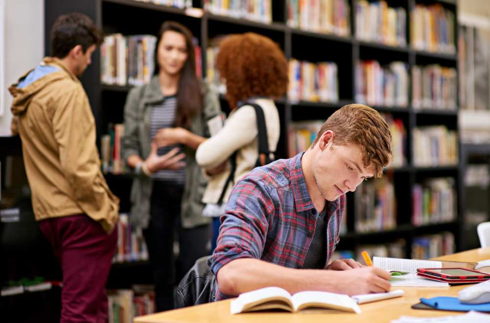 Students studying together on a college campus, symbolizing digital marketing for colleges and higher education growth.