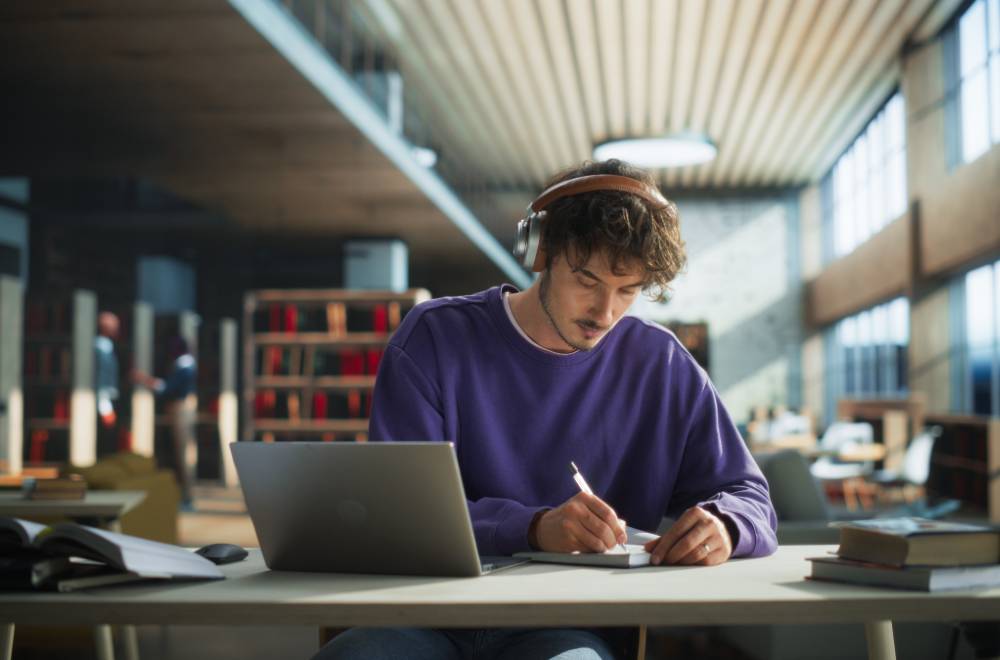 Student studying in a university library, highlighting how Digital Marketing for Educational Institutions can engage prospective students.